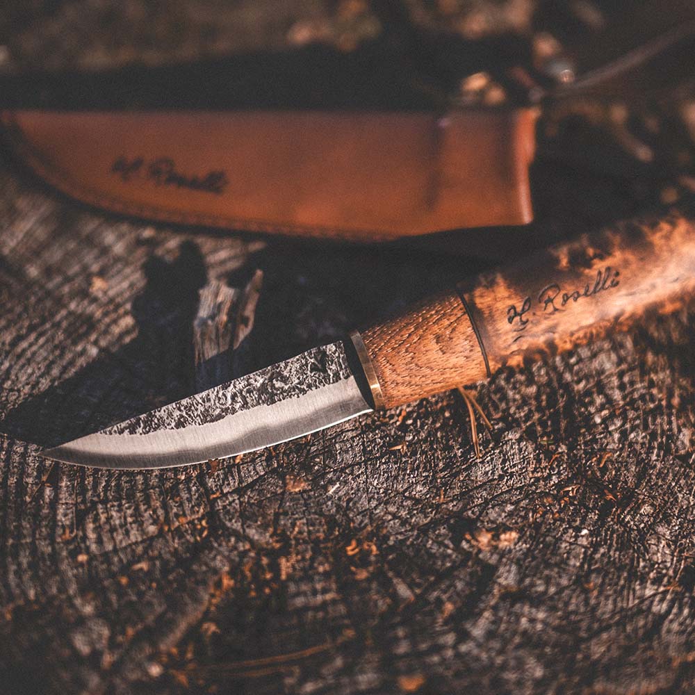 Roselli's handmade Finnish outdoor knife made of carbon steel and a handle of curly birch. Comes with a handmade sheath made from Finnish leather.