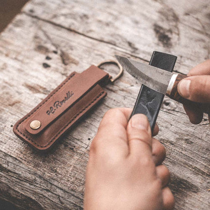 Sharpening stone in leather sheath